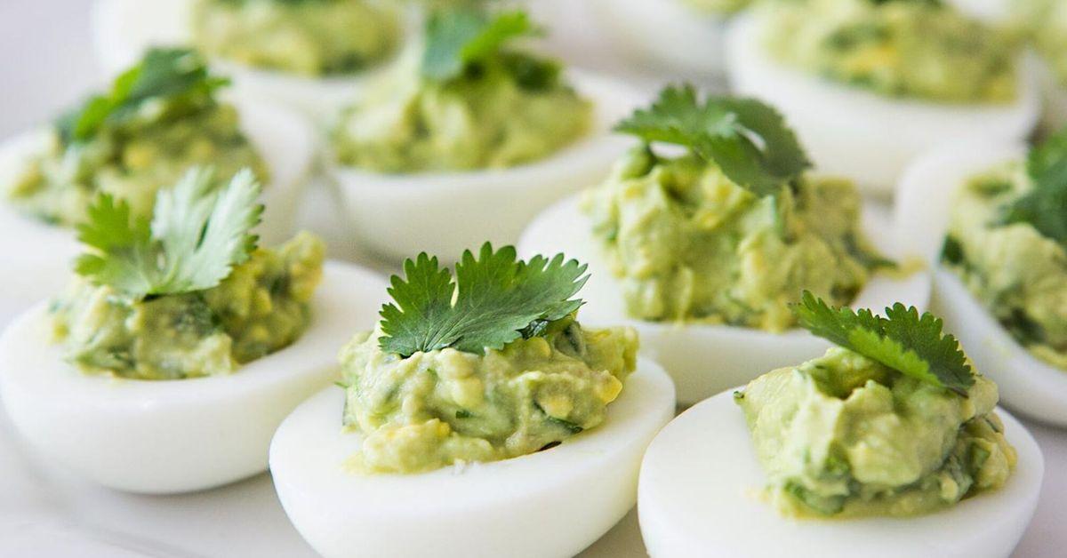 Like sushi: stuffed eggs with avocado and fish for a festive table.